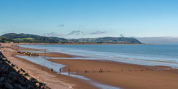 The beach in Blue Anchor, Somerset, UK with a view of the Bristol channel in the background.
