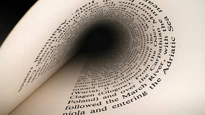 Image of a printed page rolled back into itself.