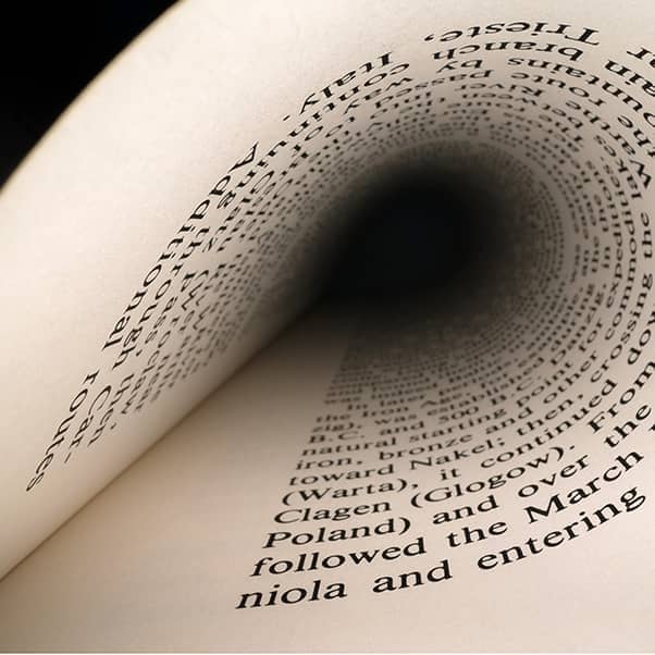 Image of a printed page rolled back into itself.