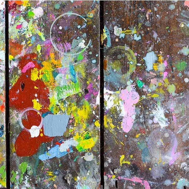 Wooden boards covered in paint creating random and abstract artistic patterns and shapes for creative background