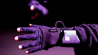 A close up of a hand wearing a virtual reality glove
