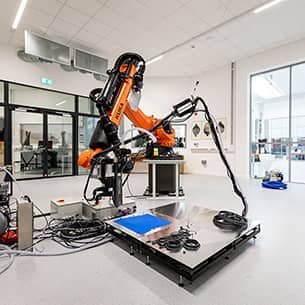 An orange robotic arm in a laboratory