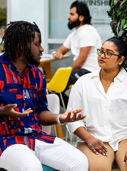 Two global majority people talking to each other.