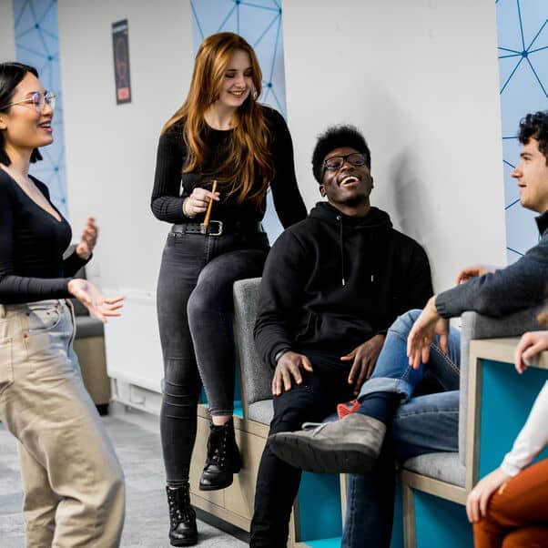 A group of students having a joyful conversation.