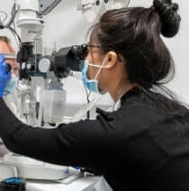 Optometry student performing an eye exam.