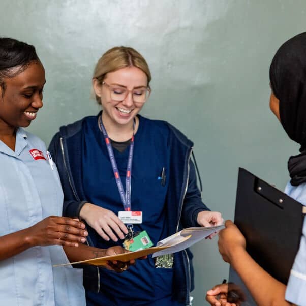 Group of nursing students looking at a chart.